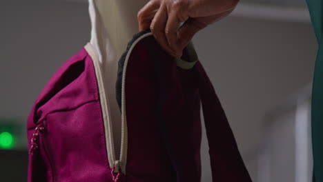 Close-Up-Of-Woman-At-Gym-For-Exercise-Class-Opening-Zip-Of-Sports-Bag-And-Taking-Out-Towel