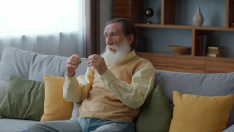 senior man checking his temperature at home