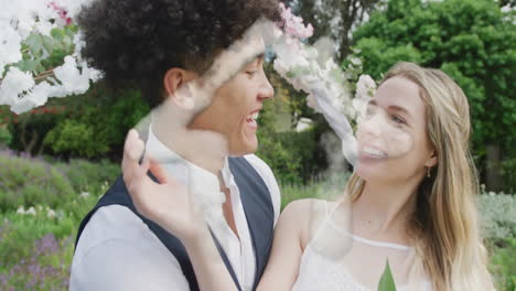 Animación-De-La-Casa-De-Las-Nubes-Sobre-Una-Feliz-Pareja-Diversa-Sonriendo-En-El-Jardín-El-Día-De-La-Boda