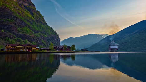 Timelapse-shot-of-large-ship-arriving-at-Port-of-Flam-in-Norway-during-beautiful-evening-time