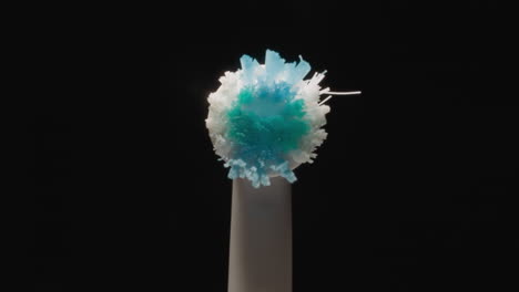 tip of used electric toothbrush with colorful hard bristle