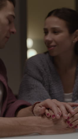 couple holding hands in a cozy setting