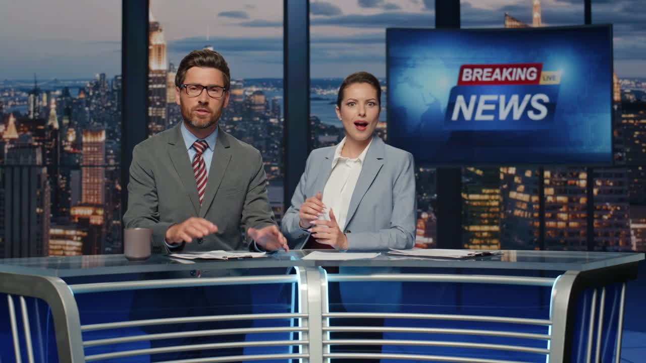 Broadcast presenters reporting news at late night television channel closeup