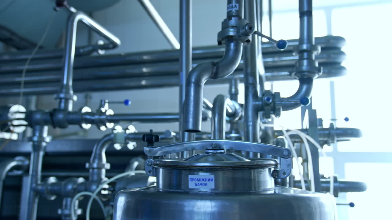 Industrial Milk Production Facility. Modern steel machines at industrial conveyor line of soft drink production plant