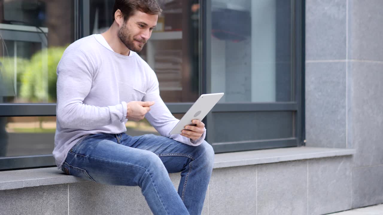 Excited Man Celebrating Success on Laptop Sitting on Stairs