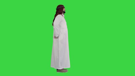 Arab sheikh wearing keffiyeh standing on a Green Screen, Chroma Key