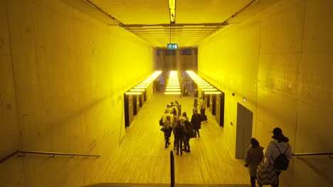 yellow illuminated corridor with people