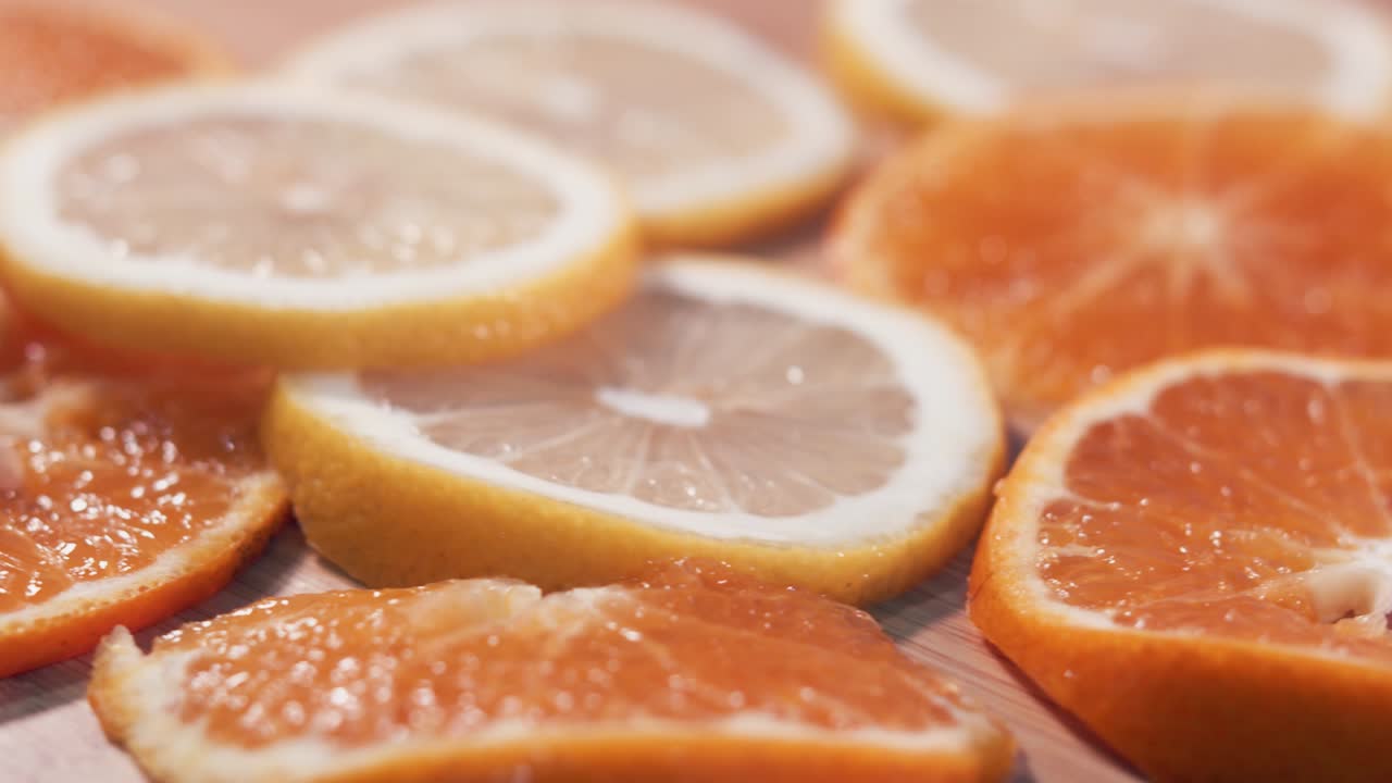 Close Interior Static Shot of Spinning Slices of Oranges and Lemons