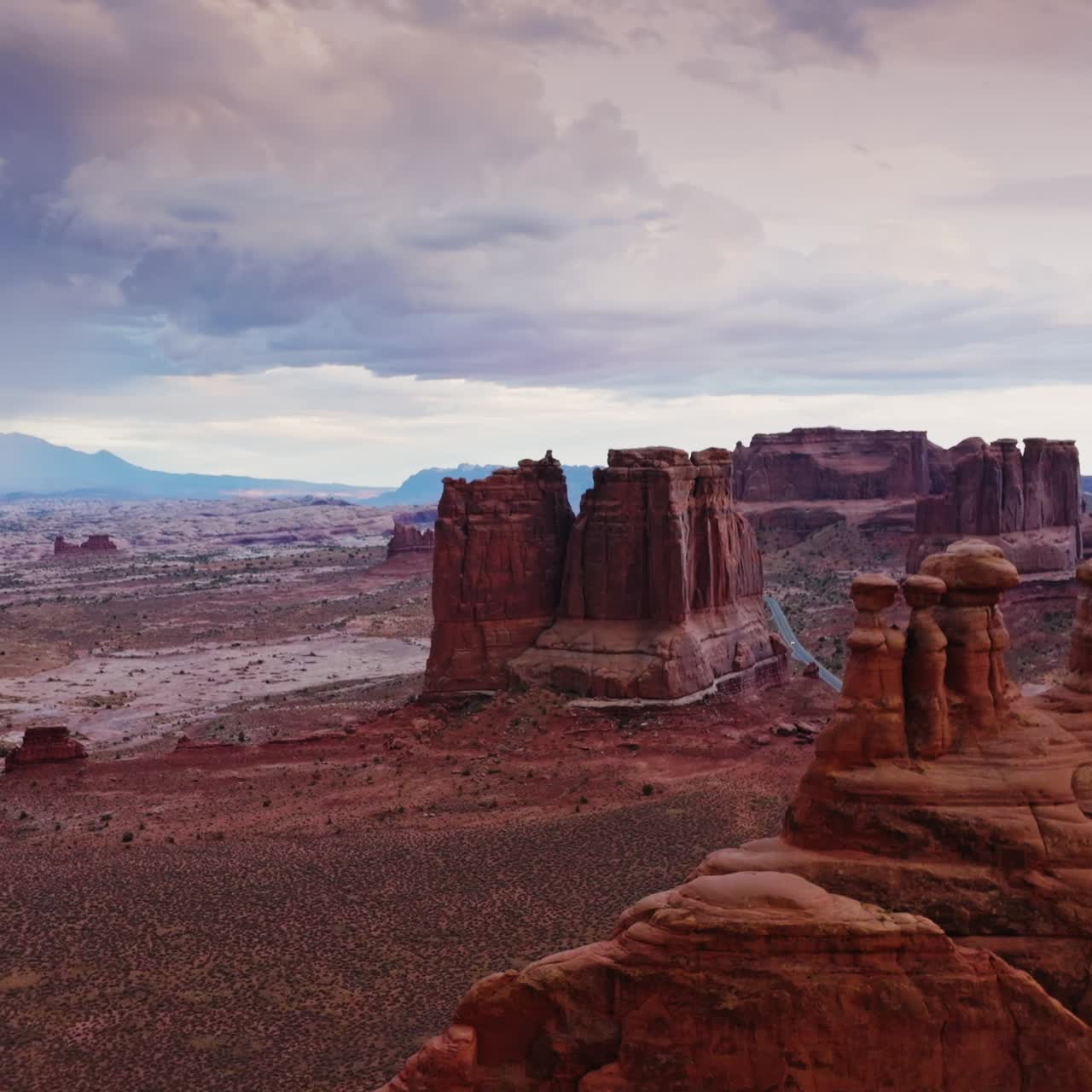 Arches national park in the cloudy daytime. Scenic view of tremendous rocks among the desert plain. Aerial view