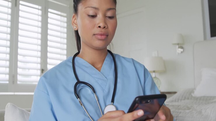 Young female nurse using smartphone