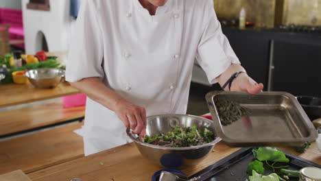 caucasian female chef teaching diverse group preparing dishes and smiling