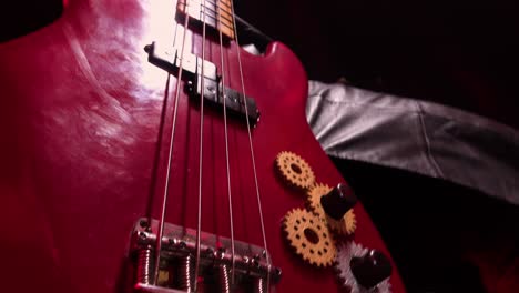 red bass guitar with gears