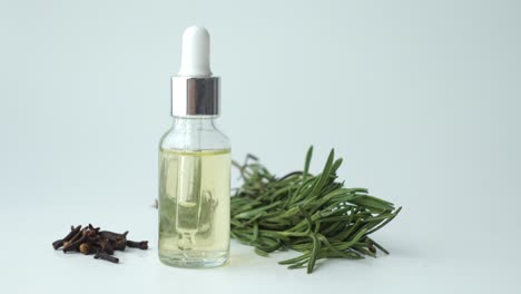 rosemary essential oil in a glass bottle with dropper