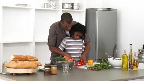 panorama of father and son cutting vegetables in the kitchen