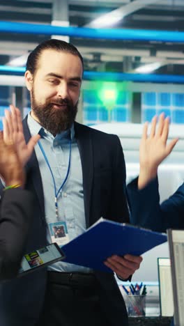 vertical video pleased supervisors celebrating passing solar plant inspection, doing high five