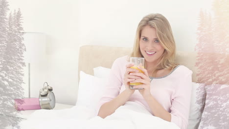 animation of smiling woman sitting in bed drinking, over misty mountain landscape