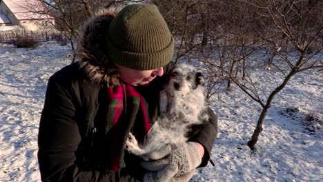 hombre en manos con perro pequeño