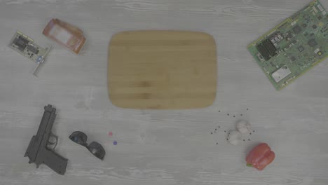 surreal still life with bread, gun, and electronics