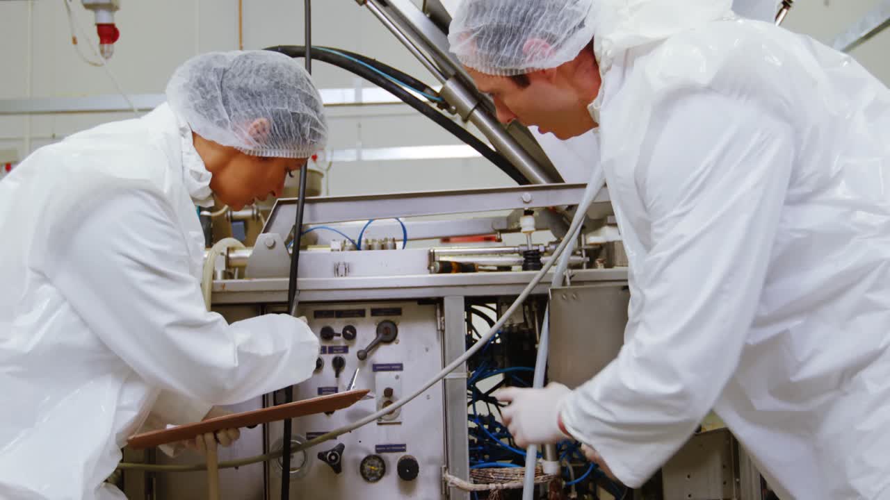 Team of butcher examining machine
