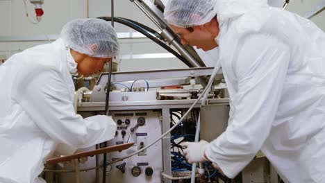 team of butcher examining machine