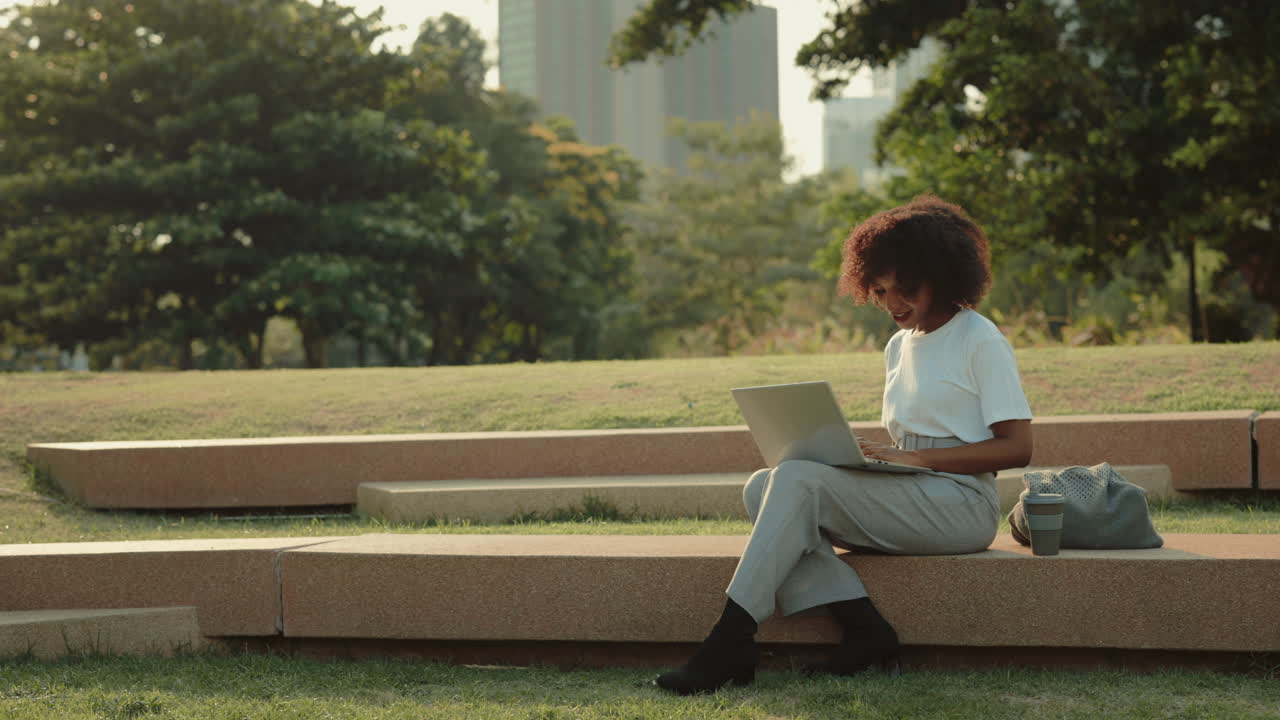 Businesswoman working on laptop in park