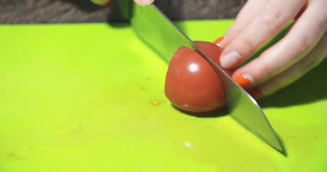 slicing tomato in kitchen 2