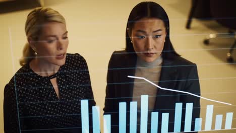 two business professionals analyze decreasing financial trends on a digital dashboard, engaging in a serious discussion during a corporate meeting