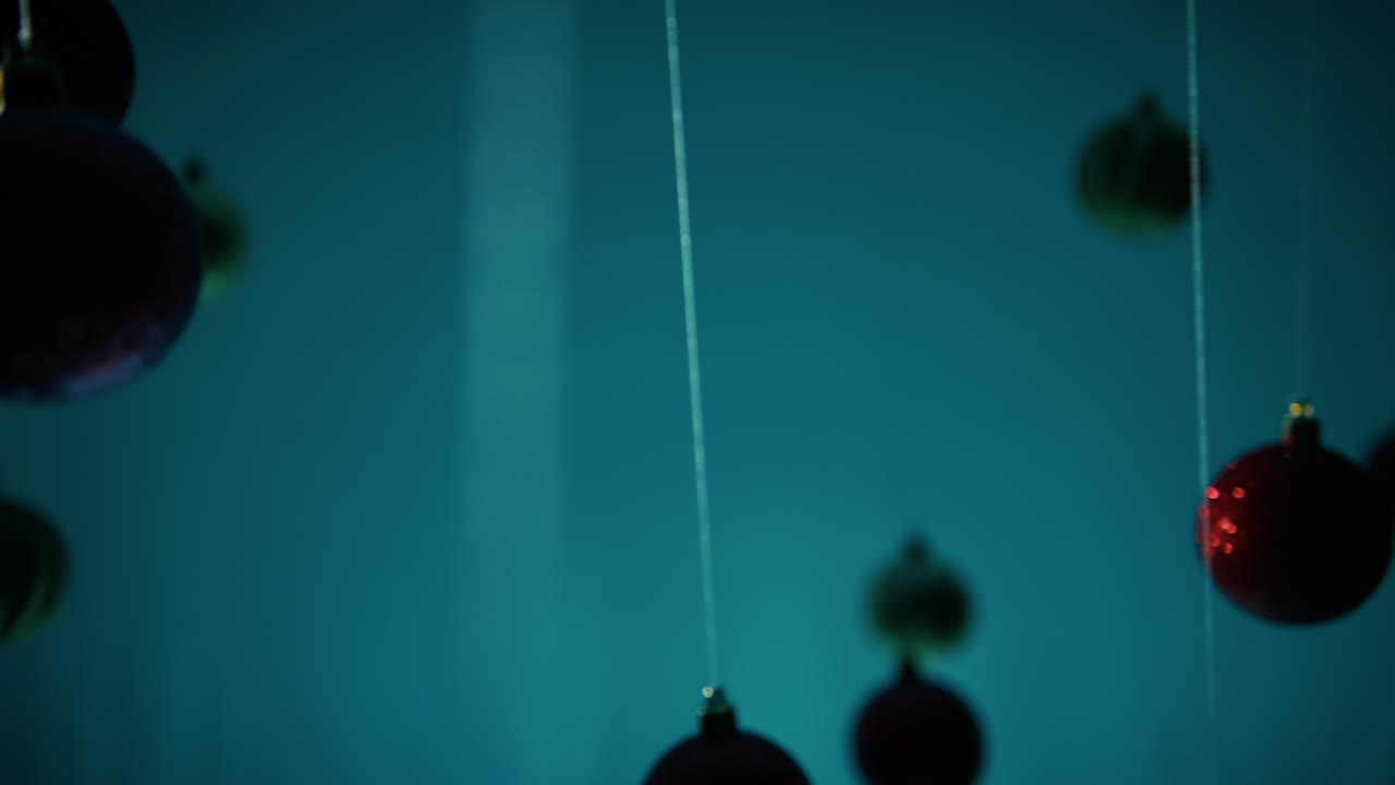 Sad Christmas balls swing alone on a string