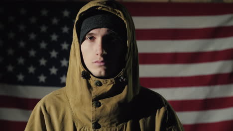 Portrait-Of-A-Young-Male-Soldier-On-The-Background-Of-The-American-Flag