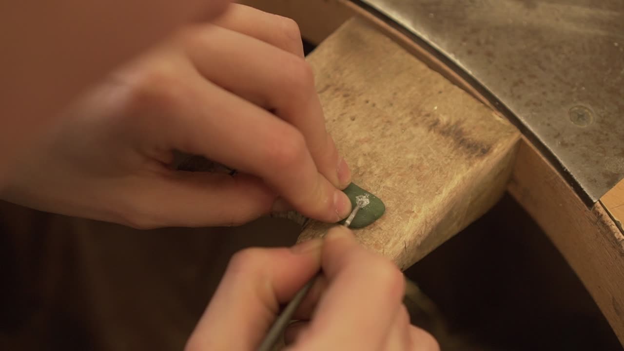 cerca del pequeño agujero de acabado en piedra verde de nueva zelanda con archivo redondo - cámara lenta