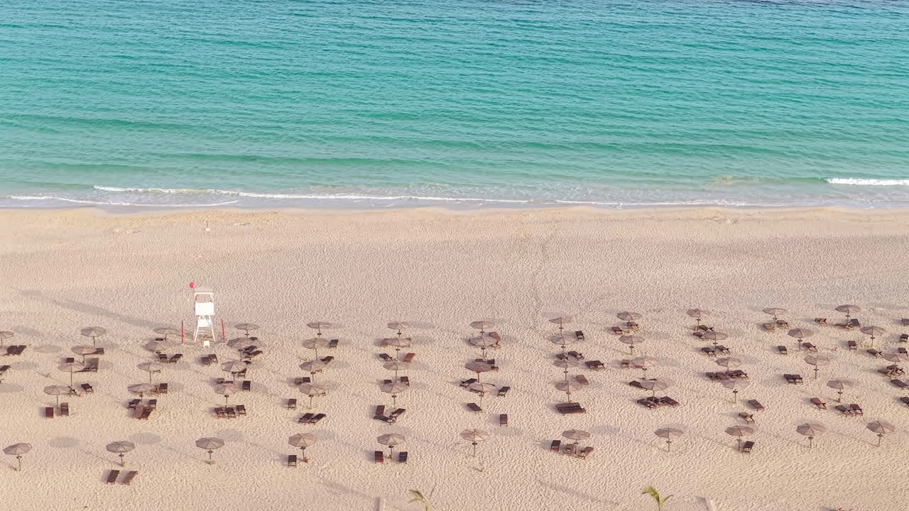 Aerial View of a Tropical Beach with Umbrellas and Chairs