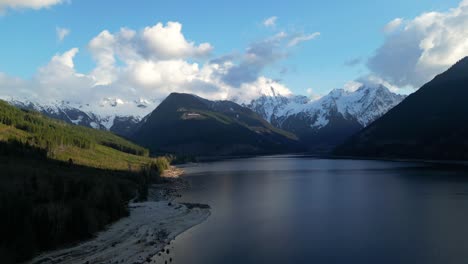 Pintoresco-Lago-Rodeado-De-Paisaje-Montañoso-Con-Nieve-Y-árboles