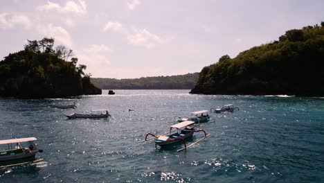 Traditional-outrigger-canoes-anchored-at-Crystal-Bay,-Nusa-Penida