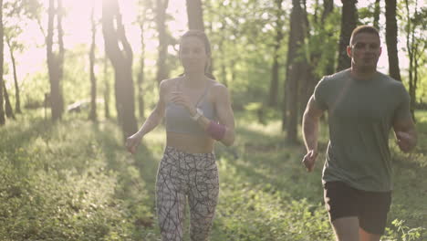 couple jogging in the woods