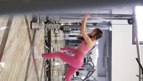 european woman wrestles her beautiful body in the gym. professional athlete during muscle training in the gym. sports lifestyle concept