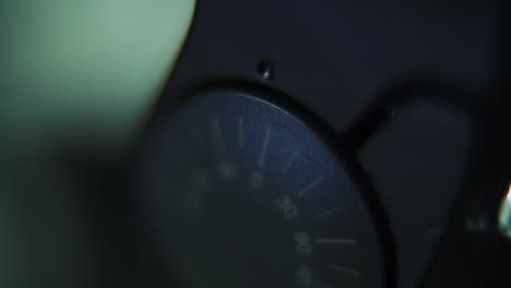 Macro-shot-of-a-tripod-plate-close-up,-camera-gear,-metal-button,-silver-screw,-smooth-tilt-up-crane-movement,-120fps-slow-motion,-Full-HD