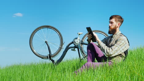 a young bearded man uses a tablet