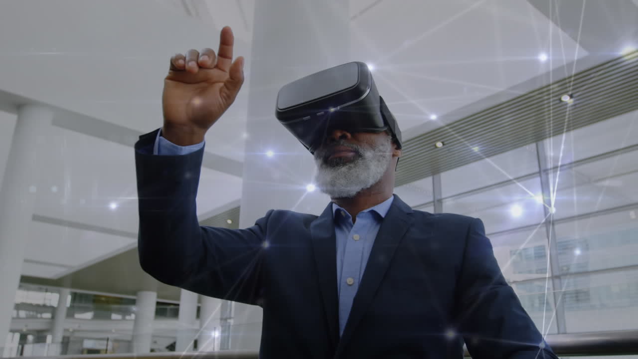 Old man wearing a virtual reality headset while waving his fingers