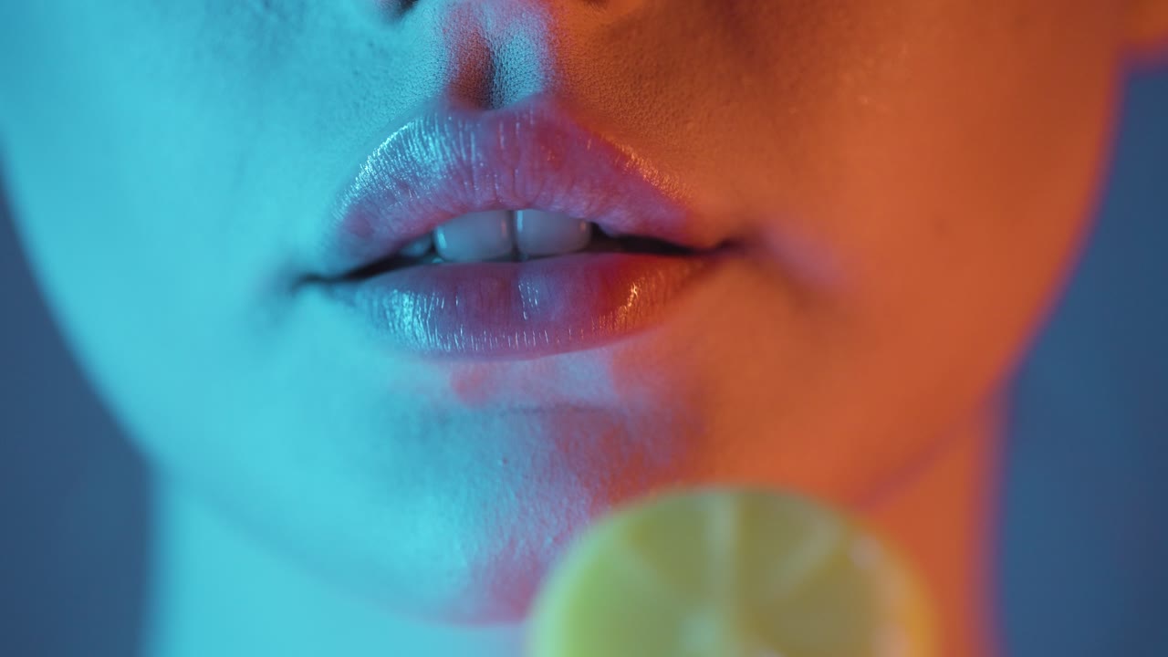 Woman holding a lollipop and licking her lips