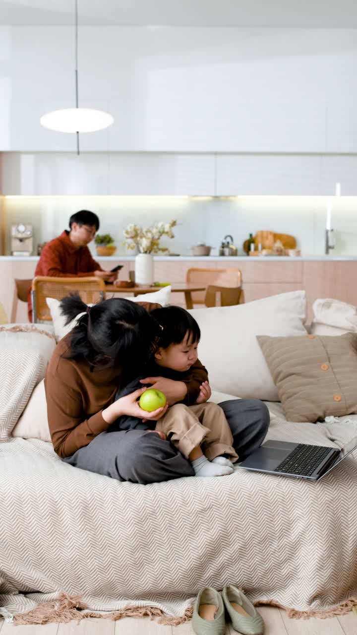 Mother and Child Watching Laptop in Living Room