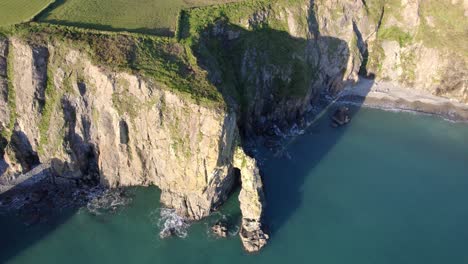 drone circling dramatic rock formations and seascapes copper coast waterford ireland