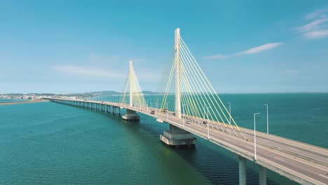 establishing shot of traffic on beautiful bridge above the ocean