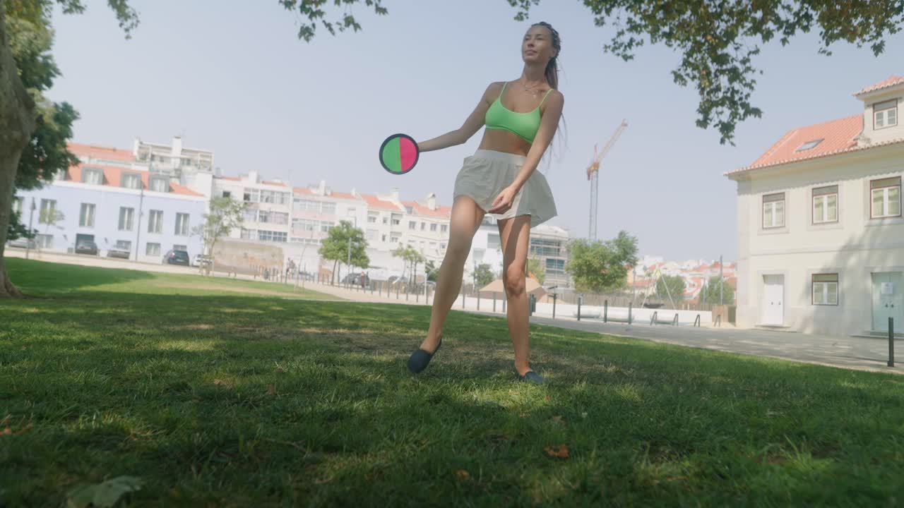 Woman playing with a hacky sack in a park