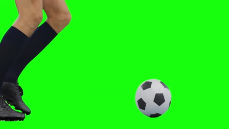 Video-of-legs-of-caucasian-male-soccer-player-kicking-ball-on-green-screen-background