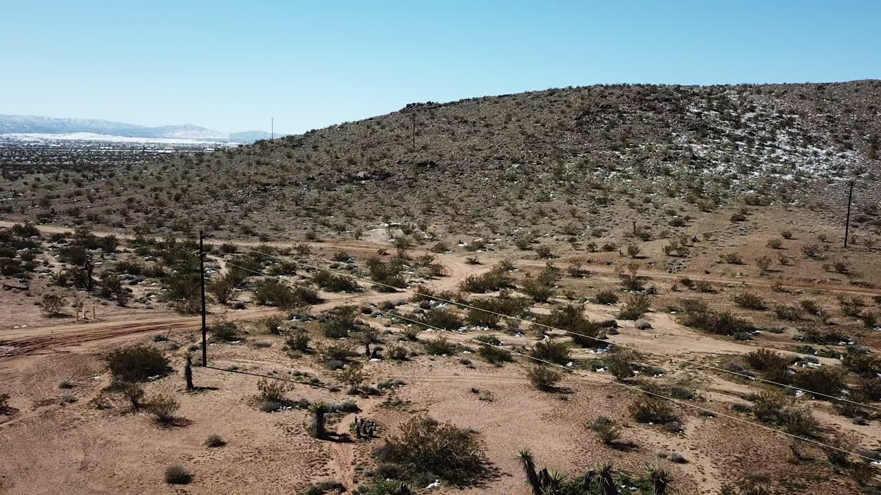 Aerial Drone Shot Flying over Construction of A-Frame Cabin in Joshua Tree Desert