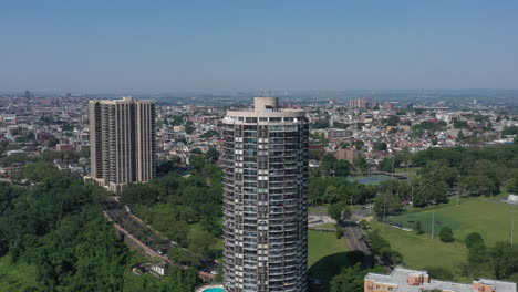 A-drone-view-of-a-cylindrical-building-on-the-New-Jersey-side-of-the-Hudson-River,-on-a-sunny-day