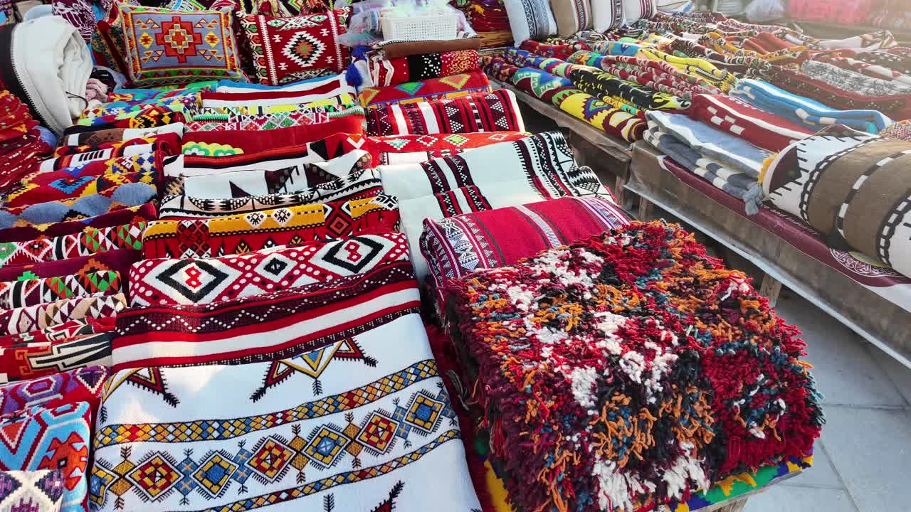 Display of colorful rugs and textiles
