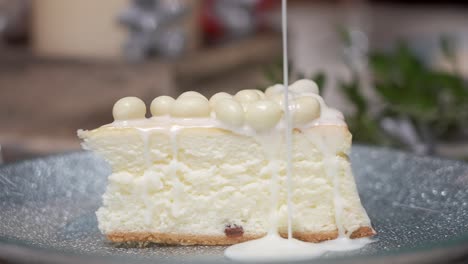 Close-up-shot-pouring-white-chocolate-sauce-onto-a-cake