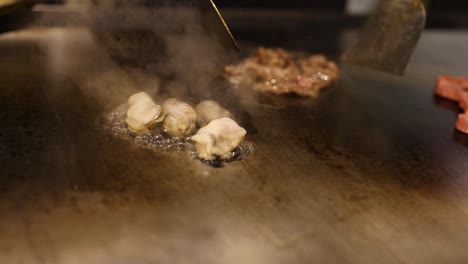 chef expertly prepares food on hot griddle