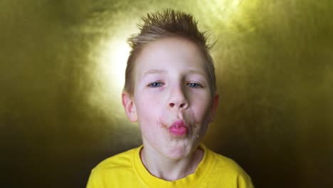 blond enjoys sweets. happy kid eating a sugar donut. child snacking on junk food.